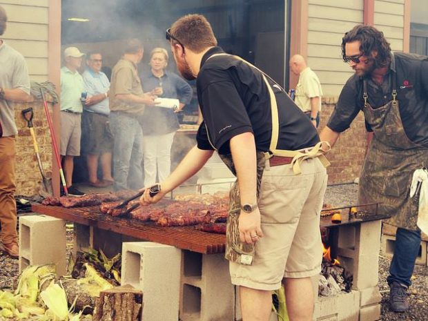 cooking ribs for auction dinner event Mossy Oak Properties Fox Hole Shootout