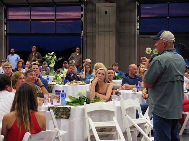 speaker at auction dinner event during Mossy Oak Properties Charity Event