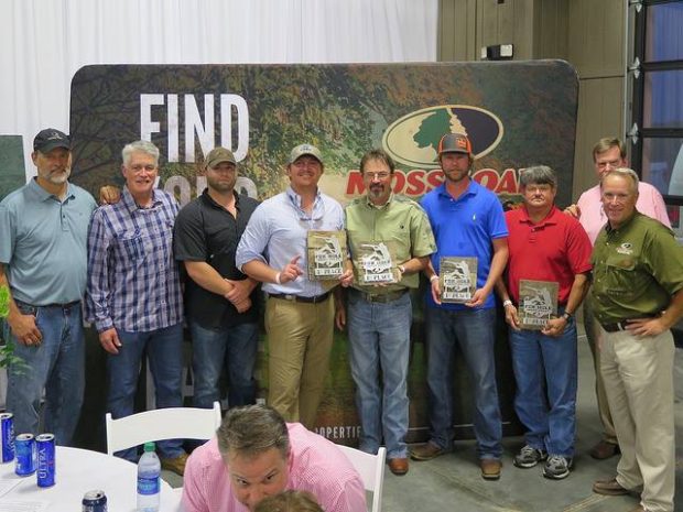 winners at auction dinner event mossy oak property golfing tournament