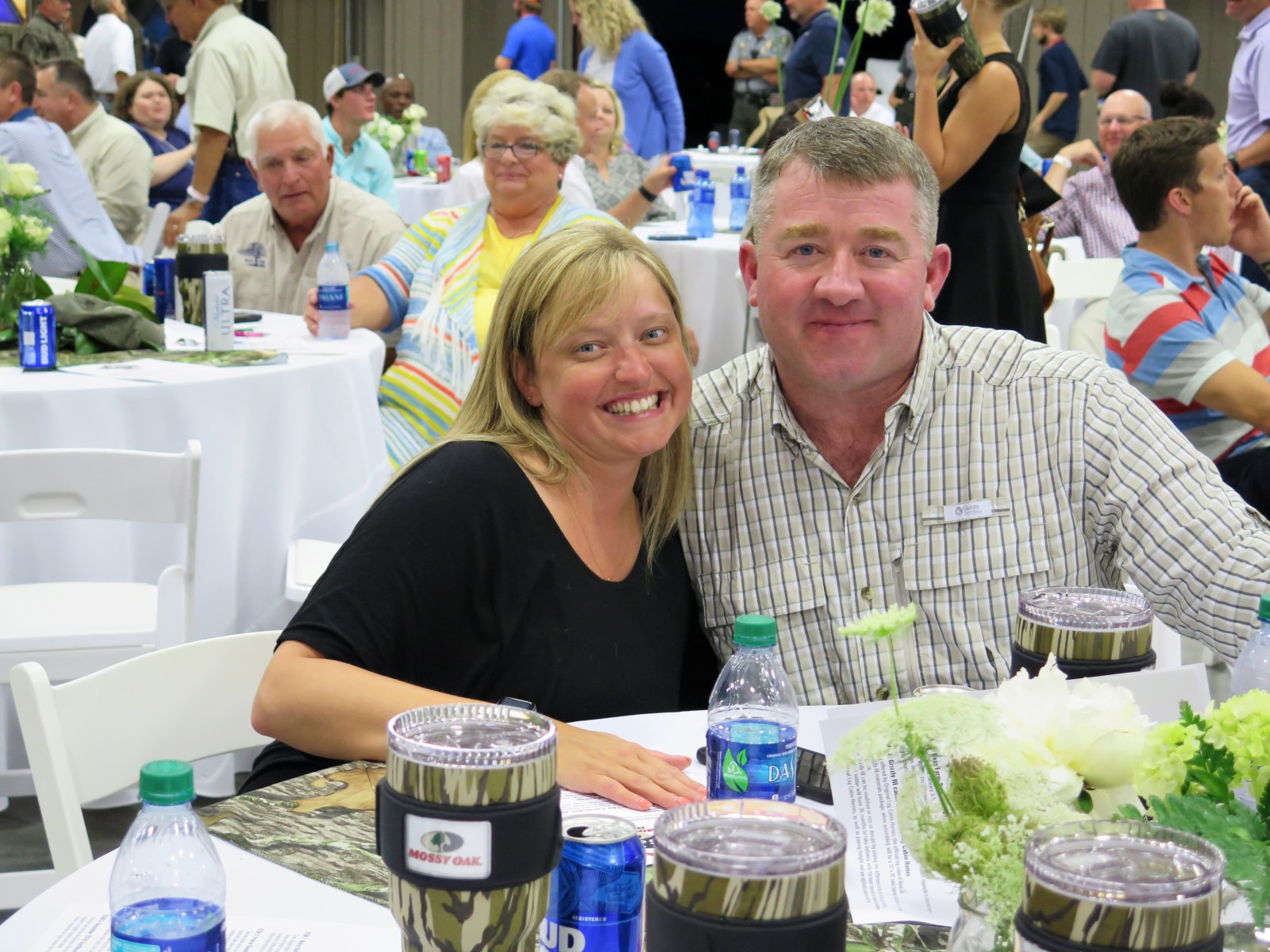 couple at auction dinner during cooking ribs for auction dinner event Mossy Oak Properties Fox Hole Shootout